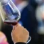 A woman drinking wine at a business function
