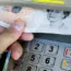 A man withdraws cash at an ATM