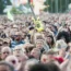 A festival goer holds an inflatable guitar at the Isle of Wight Festival, Seaclose park, Newport, on the Isle of Wight