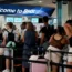 Passengers queue at Birmingham Airport
