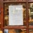 A cash only sign on the window of a Cambridge shoe shop