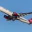 A Virgin Atlantic Airbus A330-941 plane climbing out of Heathrow Airport on a sunny, late autumn evening