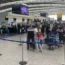 Passengers queue to check-in at terminal 2 at Heathrow Airport, London