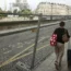 A woman pulls her luggage along fences of the security perimeter in Paris (Thomas Padilla/AP)