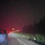 A fire on the horizon seen from a road