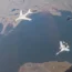 A long-range bomber of the Chinese air force is escorted by a Russian Su-30 fighter