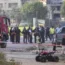 Israeli police officers and firefighters at the site of a rocket attack in the Israeli-controlled Golan Heights