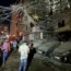 People gather near a destroyed building that was hit by an Israeli airstrike in the southern suburbs of Beirut, Lebanon