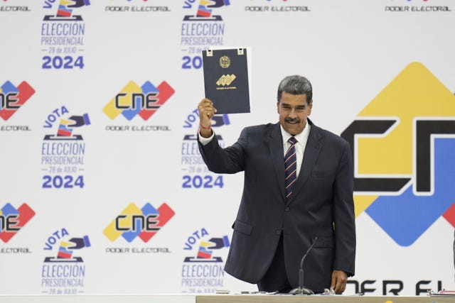 68dc9715193a4057b3ac741ab92dd75d Venezuelan President Nicolas Maduro holds up his certification from the National Electoral Council (CNE) that declares him the winner of the presidential election, at the CNE in Caracas, Venezuela