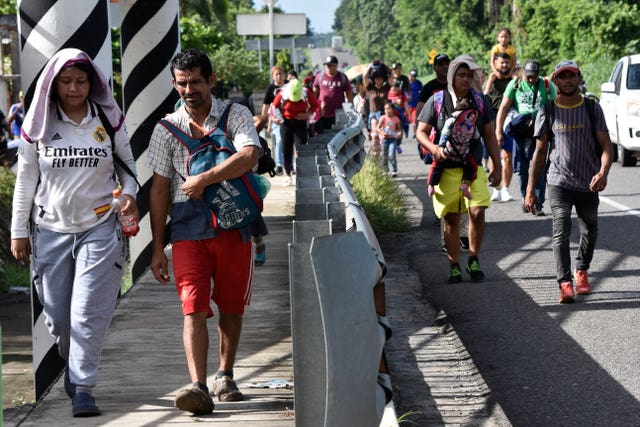 d0c48bc0c7e84ead94a2dcea4d54d6b6 Migrants walk along the highway through Suchiate, Chiapas state