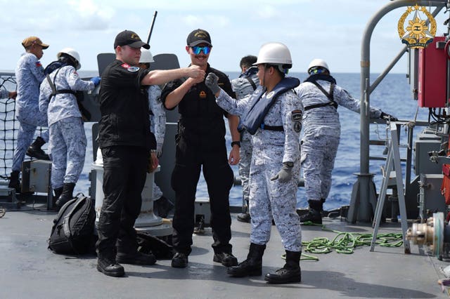 031bd216c9d641719f6f45dd011947df Fist-bumps on deck as navy personnel meet