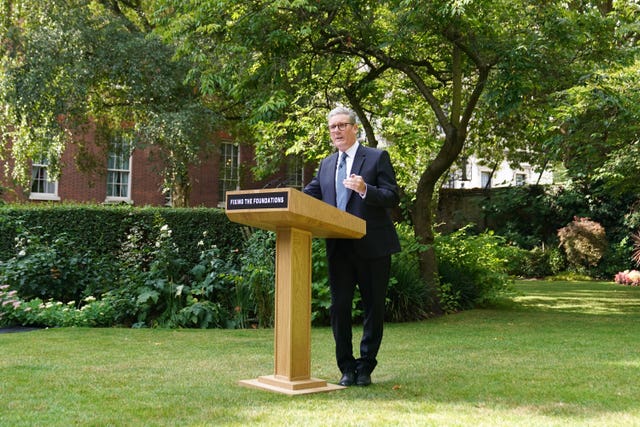 2-77241316 Sir Keir Starmer standing behind a podium with the words 'fixing the foundations' on it in the rose garden of 10 Downing Street