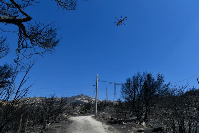 20fe8cb99e414d96a702063b94e8c688 A firefighting helicopter flies in the Nea Penteli suburb of Athens