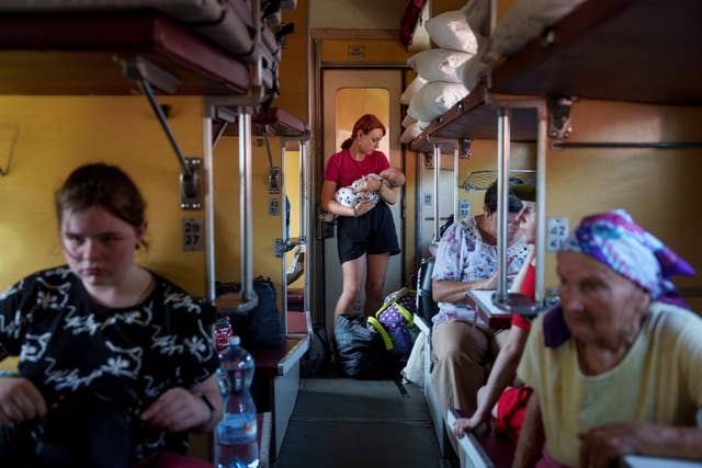 40e42b7ff602434785ea63b91f49a6be A girl calms her sister on an evacuation train in Pokrovsk, Donetsk region, Ukraine