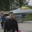 A fighter jet with a man in the foreground