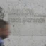 A man walking past the London Stock Exchange