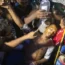 People help a man, who was injured during the anti-government protests in Bangladesh,