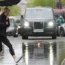 A person walking through the rain in central London (PA)