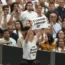 A woman holds up a placard reading 'Bullfighting is a sin'
