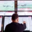 A punter places bets in a Ladbrokes shop