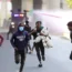 Protesters run as Kenyan police use water cannon during a demonstration in Nairobi