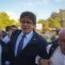 Catalan independence leader Carles Puigdemont, accompanied by his lawyer, Gonzalo Boye (right), arrives in Barcelona