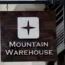 Wooden Mountain Warehouse sign hanging on white wall