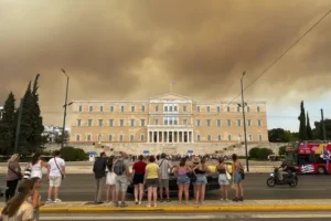 A wildfire near the Greek capital darkens the skies over Athens