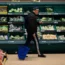 A shopper walks through an aisle at a supermarket