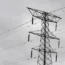 An electricity pylon against a grey sky