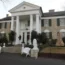 A large brick building with a white portico at the front