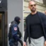 Gendarmes wearing balaclavas exit the residence of internet influencer Andrew Tate during an early morning police raid