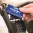 A shopper taps a Tesco Clubcard on a reader