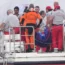 The fifth body bag is brought ashore at the harbour in Porticello by rescue workers searching for the six tourists missing after the luxury yacht Bayesian sank in a storm on Monday whilst moored around half a mile off the Sicilian coast.