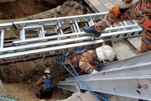 Woman plunges into 26ft hole after pavement collapses in Malaysian capital
