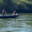 Rescue Service members search a Drina River near the town of Bratunac, Bosnia