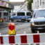 Police cars sit at a cordon