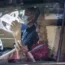 The Dalai Lama waves from a car