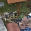A bolt action rifle lying on a log