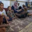 Displaced infant Abdel-Rahman Abu El-Jedian, 11-month-old, who suffers from polio, is carried by his mother, centre, at a makeshift tent camp in Deir al-Balah, central Gaza Strip