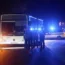 Police stand in front of a bus