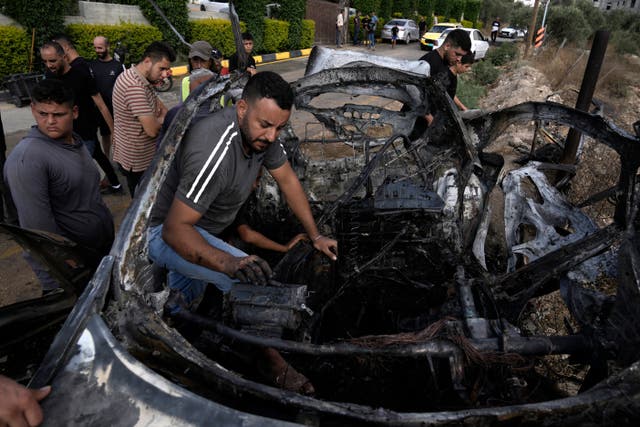 ad50cdd2884e477f85d93b3e56abc5da A man inside the charred car