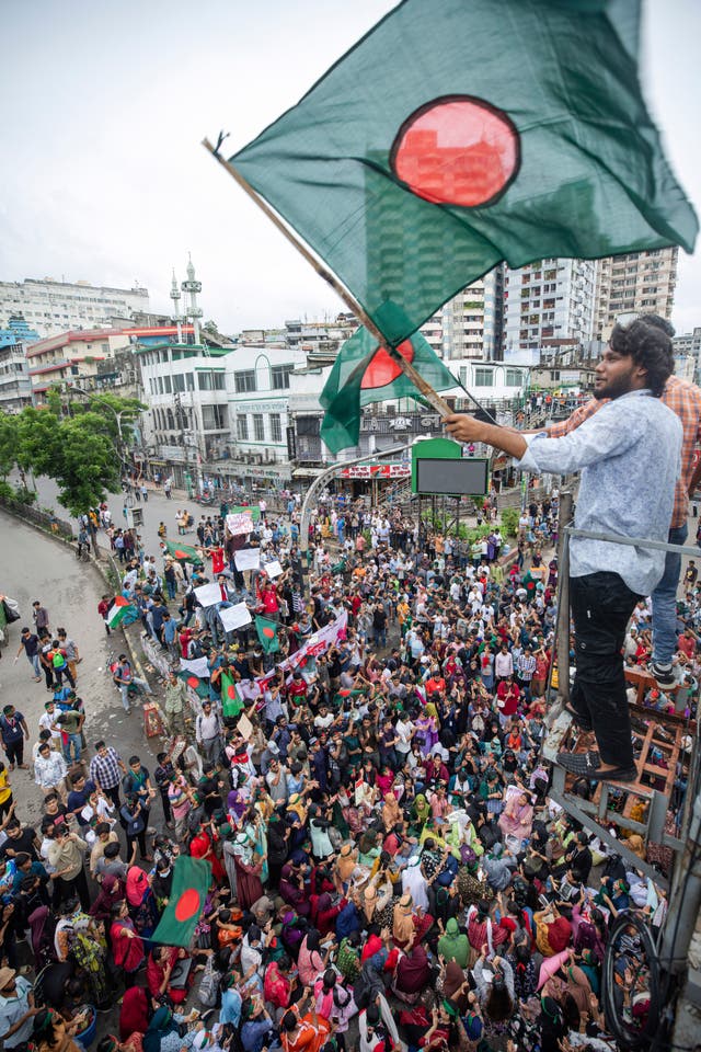 b82ac839961e4c11b663b34a4c7379b1 An activist waves a Bangladesh flag during a protest march