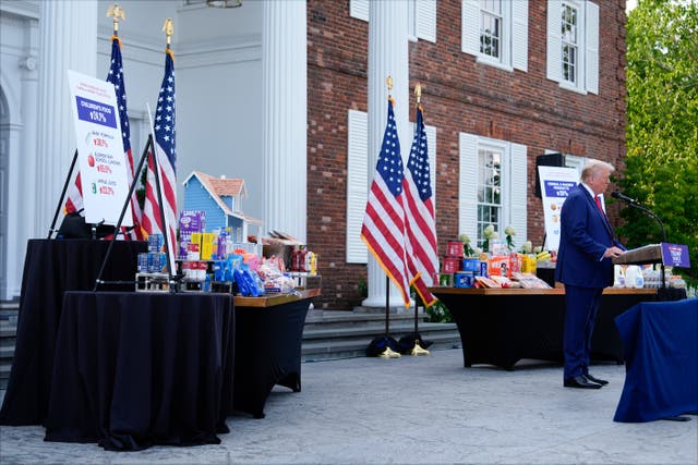 c320784596a349c3985751daef857b98 With consumer goods placed on tables near him, Republican presidential nominee Donald Trump speaks at a news conference (Julia Nikhinson/AP)