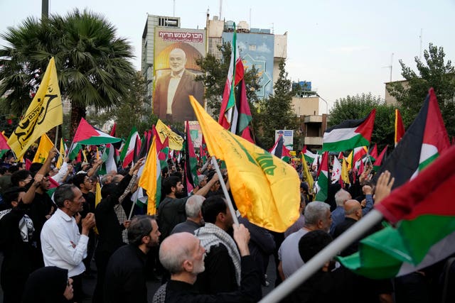 dd7398c344dc47328ef144d1719d5398 Iranian protesters wave Iranian, Palestinian and Lebanon’s militant Hezbollah group flags in a demonstration