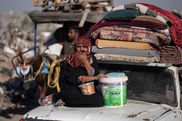 dee56f6a28574e3e9b64970e3eebad0f-1 A Palestinian woman flees the Khan Younis area of the Gaza Strip