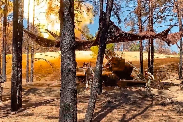 e7df5d74205a48f3853abd0c481b8870 Russian soldiers fire from a 203-mm self-propelled gun 2S7 'Pion' towards Ukrainian positions in an undisclosed location in Ukraine