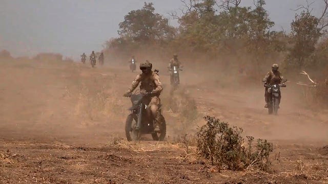f18d6c2248cb4c82a5781feea30152c4-1 A marine assault team members ride motorcycles toward Ukrainian position at an undisclosed location