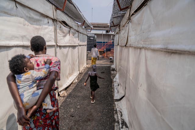 A girl suffering from mpox walks past a treatment centre in Munigi, Democratic Republic of the Congo