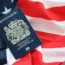 British passport on United States national flag background close up.